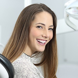 Smiling woman in dental chair | Tooth Colored Dental Fillings Andover MA 01810