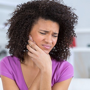 Woman holding jaw in pain