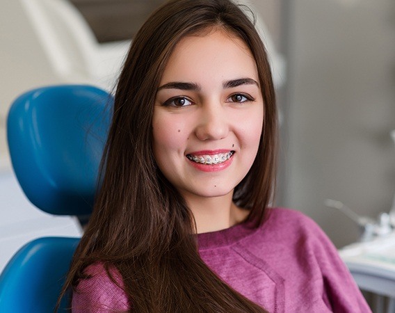 Woman with braces in dental chair | Invisalign Clear Aligners and Braces | Dentist Andover MA 01810