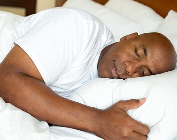 Man sleeping soundly in bed