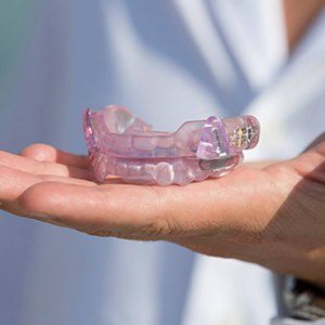 Hand holding an oral appliance